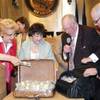 This image provided by the city of Las Vegas shows, from left, Mayor Carolyn G. Goodman, Councilwoman Lois Tarkanian, Oscar B. Goodman and The Mob Museum Executive Director Jonathan Ullman, displaying the $1.5 million in cash paid to the city at a council meeting on April 16, 2014.