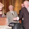 Former Las Vegas Mayor Oscar Goodman hands one of the stacks of hundred dollar bills to current Las Vegas Mayor Carolyn G. Goodman after The Mob Museum paid the city a whopping $1.5 million in cash at a council meeting on April 16, 2014.
