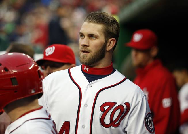 Washington Nationals left fielder Bryce Harper walks in the dugout during a baseball game against the St. Louis Cardinals at Nationals Park on Friday, April 18, 2014, in Washington.