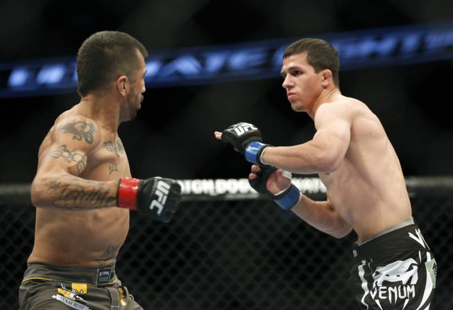 Estevan Payan, left, and Alex White fight in a mixed martial arts event on Saturday, April 19, 2014, at UFC Fight Night in Orlando, Fla. White won.