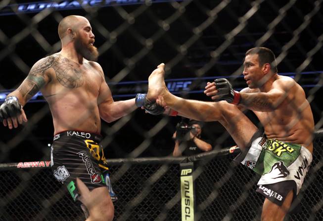 Fabricio Werdum, right, and Travis Browne fight in the main event during a mixed martial arts event on Saturday, April 19, 2014, at UFC Fight Night in Orlando, Fla. Werdum won in a decision.