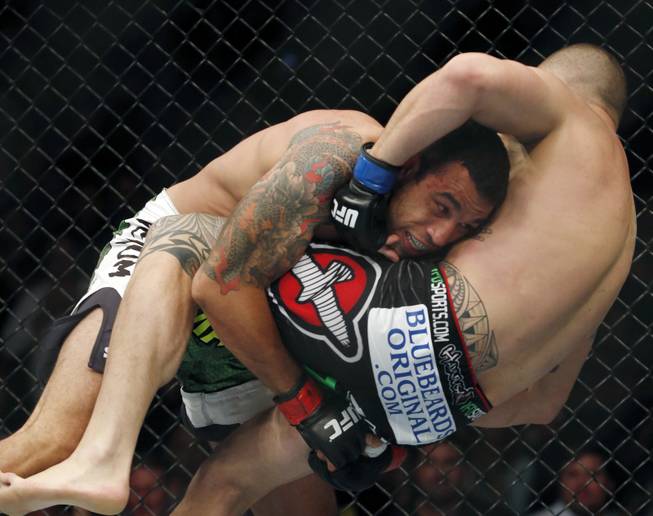 Fabricio Werdum, left, and Travis Browne fight  in the main event during a mixed martial arts event on Saturday, April 19, 2014, at UFC Fight Night in Orlando Fla. Werdum won in a decision.