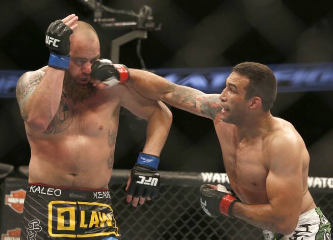 Fabricio Werdum, right, and Travis Browne fight during a UFC mixed martial arts bout on Saturday, April 19, 2014, in Orlando, Fla. Werdum won.