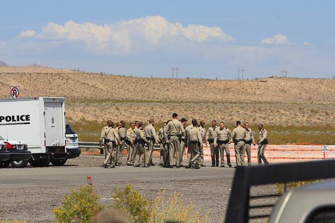 Metro Police officers confer at during the April 12, 2014 stand-off between the Bureau of Land Management and supporters of rancher Cliven Bundy near Bunkerville, Nevada. The BLM eventually called off their roundup of Bundy cattle citing safety concerns. Courtesy of Shannon Bushman.