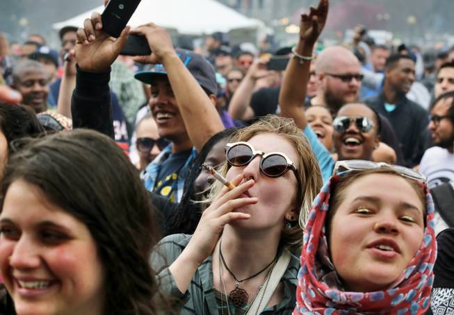 With the Colorado state capitol building visible in the background, partygoers dance to live music and smoke pot on the first of two days at the annual 4/20 marijuana festival in Denver on April 19, 2014. The annual event is the first 420 marijuana celebration since retail marijuana stores began selling in January 2014.
