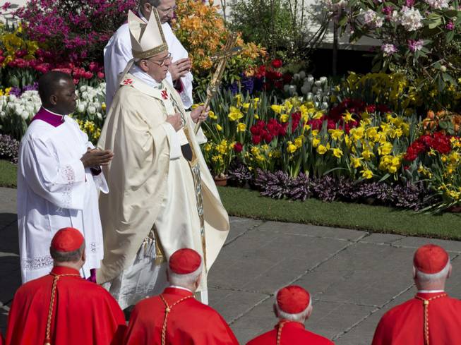 Flowers from the Netherlands decorate St. Peter's Square as Pope Francis arrives to celebrate an Easter Mass in St. Peter's Square at the the Vatican, Sunday, April 20, 2014. Francis is celebrating Christianity's most joyous day, Easter Sunday, under sunny skies in St. Peter's.