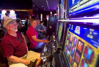 Dickie Sanders, left, of Elizabeth City, N.C. smiles as he wins $48.00 on a slot machine during the opening of the casino floor at the Cromwell, formerly Bill's Gamblin' Hall & Saloon, on the Las Vegas Strip and Flamingo Avenue, Monday, April 21, 2014. The casino will host a grand opening on May 21. The casino is undergoing a $185 million renovation project that includes remodeling of guest rooms, casino floor and common areas, the addition of a new second floor restaurant, and construction of the 65,000 square foot rooftop pool and dayclub/nightclub.