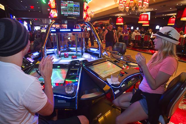 A couple plays an electronic craps machine during the opening of the casino floor at the Cromwell, formerly Bill's Gamblin' Hall & Saloon, on the Las Vegas Strip and Flamingo Avenue, Monday, April 21, 2014.