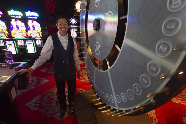 Lap Nguyen stands by the Big-Six wheel during the opening of the casino floor at the Cromwell, formerly Bill's Gamblin' Hall & Saloon, on the Las Vegas Strip and Flamingo Avenue, Monday, April 21, 2014. The casino is undergoing a $185 million renovation project that includes remodeling of guest rooms, casino floor and common areas, the addition of a new second floor restaurant, and construction of the 65,000 square foot rooftop pool and dayclub/nightclub.