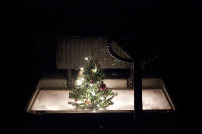 A golf cart sculpture with a lit Christmas tree placed in the seat from artist Mark Brandvik's "Volume Control" exhibit at VAST Gallery.