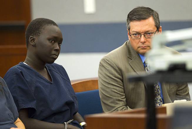 Nyakueth Tear of Salt Lake City, Utah waits with attorney Ron Paulson in court before her sentencing at the Regional Justice Center Tuesday, April 22, 2014. Tear struck eight pedestrians with her car in the street outside of a North Las Vegas church in August 2013 and fled the scene.