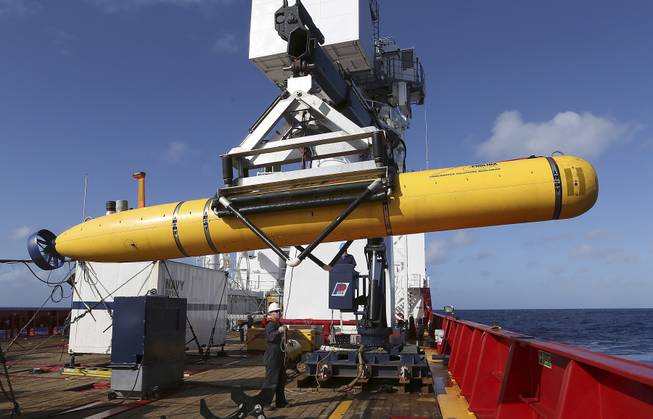 In this Thursday, April 17, 2014, photo provided by the Australian Defense Force, the Phoenix International Autonomous Underwater Vehicle (AUV) Artemis is craned over the side of Australian Defense Vessel Ocean Shield before launching the vehicle into the southern Indian Ocean in the search of the missing Malaysia Airlines Flight 370.
