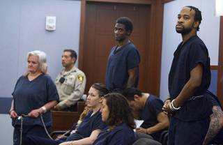 Theresa Allen, left, Emilio Arenas and Peyton Hemingway stand during a hearing at the Regional Justice Center Wednesday, April 23, 2014. The suspects are accused of torturing a homeless man before stuffing him into a suitcase and drowning him in a bathtub as they played the song 