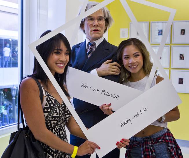 Victoria Quang and Nikki Delos Santos with an Andy Warhol cutout in the Polaroid Museum on Wednesday, April 23, 2014, at the Linq.