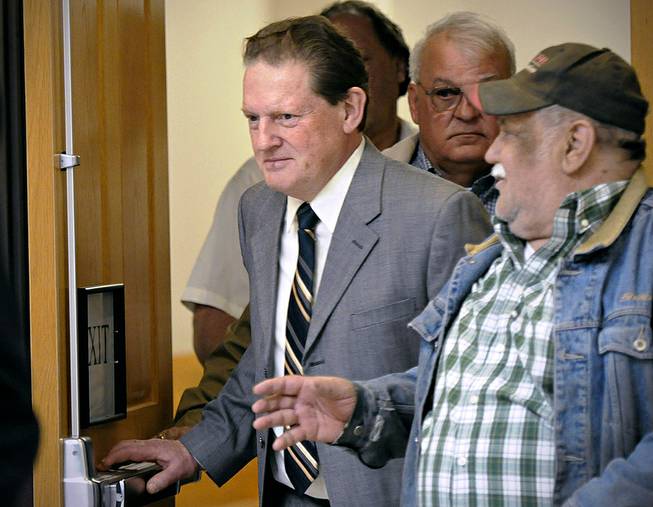 Byron Smith, center, comes out of a Morrison County courtroom in Little Falls, Minn., Monday, April 21, 2014, during a break in his trial. 