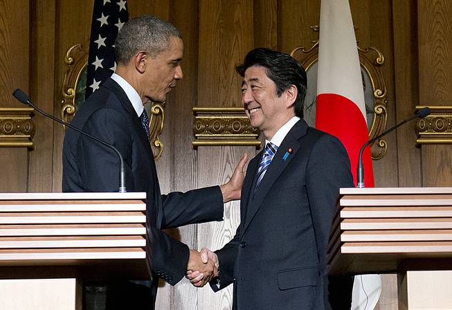 President Barack Obama, left, and Japanese Prime Minister Shinzo Abe shake hands at the conclusion of their joint news conference at the Akasaka State Guest House in Tokyo, Thursday, April 24, 2014.