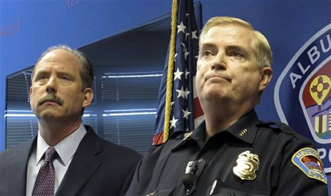 Albuquerque Mayor Richard Berry, left, and Police Chief Gorden Eden speak to reporters Thursday, April 10, 2014, after the U.S. Justice Department released a report in response to a series of deadly Albuquerque police shootings. The report pointed to patterns of excessive force by the Albuquerque Police Department, serious constitutional violations and a lack of training and oversight of its officers. Nineteen-year-old Mary Hawkes on Monday became the  third person to be killed by Albuquerque officers in five weeks, the 28th since 2010 and the first since the Justice Department issued its report.