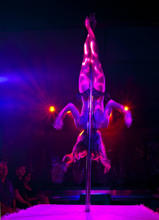 A dancer spins on a pole as “X Burlesque” celebrates its 12th anniversary in Las Vegas on Wednesday, April 23, 2014, at the Flamingo.