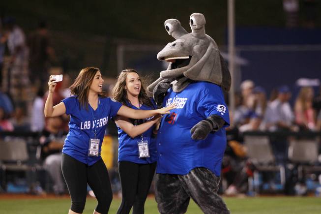 Las Vegas 51's mascot Cosmo jokes around with two women from the 51's marketing department between innings of their game against the El Paso Chihuahuas April 19, 2014.