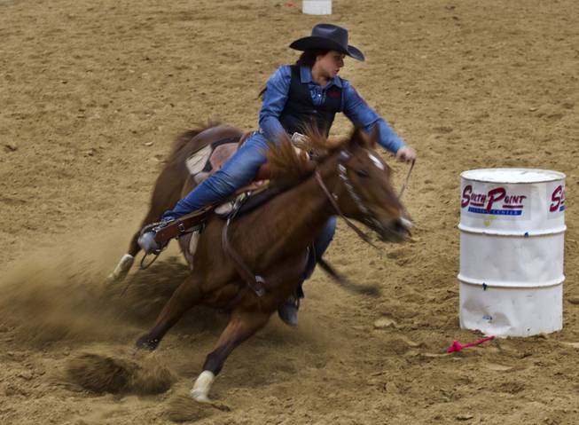 UNLV barrel racer McKena Treasure turns the corner during the West Coast Regional Finals Rodeo at South Point Arena on Friday, April 25, 2014.