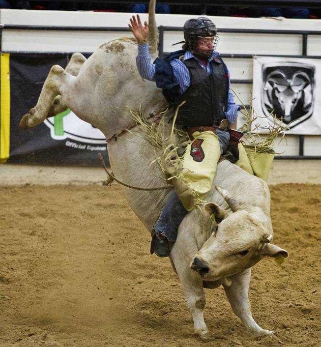 West Hills bull rider Dustin Marberry stays in control during his ride at the West Coast Regional Finals Rodeo at South Point Arena on Friday, April 25, 2014.