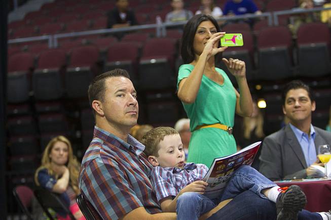 Rian Glassford and his son Dain, 5, attend the Animal Foundation's 11th annual Best in Show competition at the Orleans Arena Sunday, April 27, 2014. Radio personality Dayna Roselli takes a photo in the background.