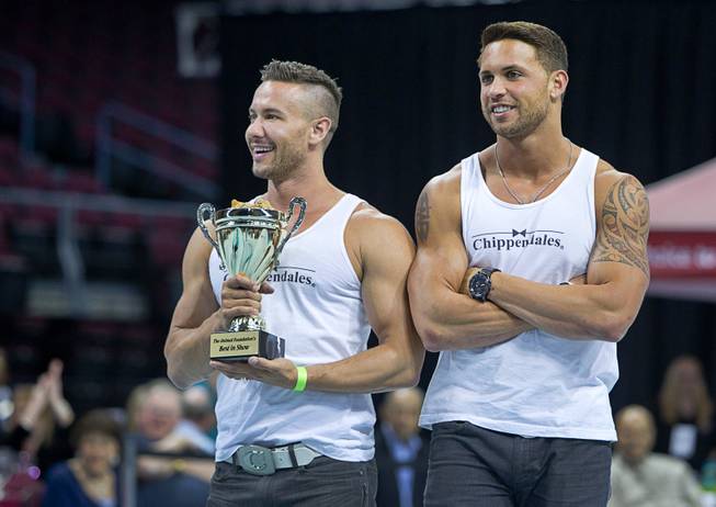Special guests Ryan Stuart, left, and Matt marshall of the Chippendales hold the trophy during the Animal Foundation's 11th annual Best in Show competition at the Orleans Arena Sunday, April 27, 2014.