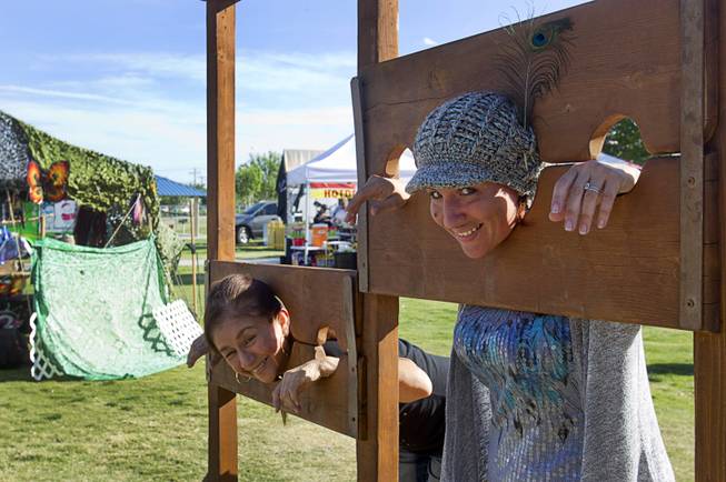 Angie Campa, left, and Gwendolyn Mentzel pose in stocks during the second annual Pirate Festival Las Vegas in Lorenzi Park Sunday, April 27, 2014.