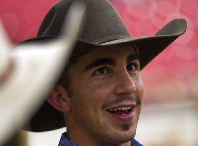 UNLV rodeo competitor Tyler Baeza chats with teammates before the start of the West Coast Regional Finals Rodeo at South Point Arena on Friday, April 25, 2014.