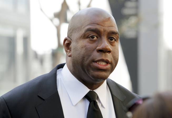 In this Feb. 21, 2013, photo, former Los Angeles Lakers player Earvin "Magic" Johnson arrives at a memorial service for Jerry Buss in Los Angeles. Johnson is calling upon NBA Commissioner Adam Silver to "come down hard" on Los Angeles Clippers owner Donald Sterling, who is alleged to have made racially charged comments. Johnson was a subject of the comments Sterling allegedly made on an audio recording obtained and released by TMZ. 