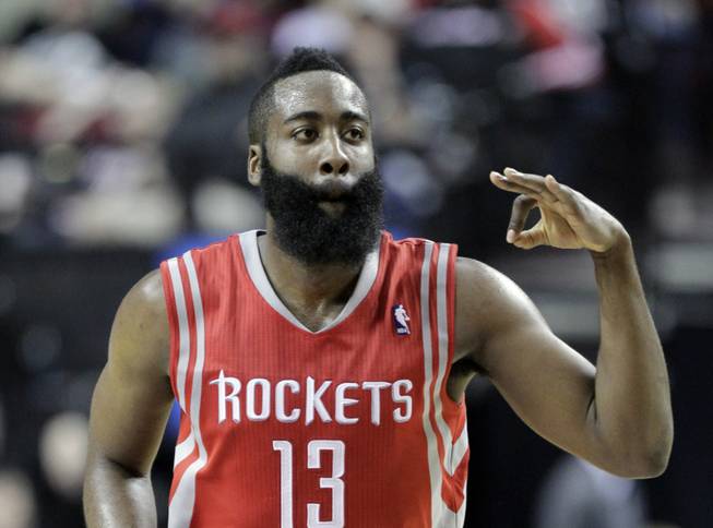 Houston Rockets guard James Harden flashes three fingers after scoring a 3-point shot during the second half of Game 3 of an NBA basketball first-round playoff series against the Portland Trail Blazers in Portland, Ore., Friday, April 25, 2014. Harden scored 37 points as the Rockets won 121-116. 