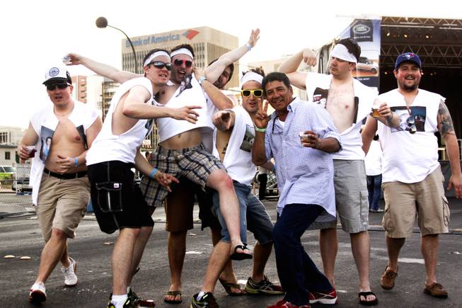 A bachelor party group for Jared Crawford, second left, pose for a photo during the "Great Vegas Festival of Beer" gathering on Fremont East Entertainment District Saturday, April 26, 2014.