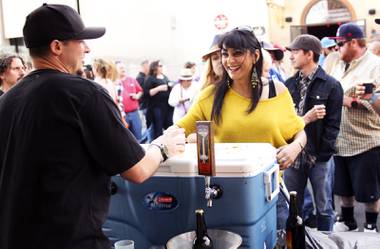 Kevin Lingley at the Highwater Brewing booth hands festival goer Vandana Chima-Bhalla a sample of their beer during the “Great Vegas Festival of Beer” gathering on Fremont East Entertainment District Saturday, April 26, 2014.