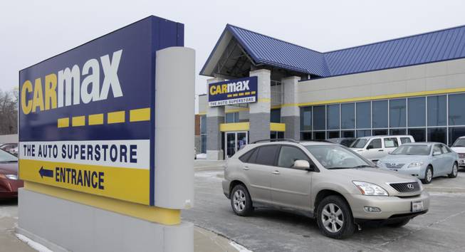 In this file photo taken Monday, Dec. 20, 2010, a car drives past the CarMax sign at the dealership in Oak Lawn, Ill. CarMax on Monday, April 28, 2014, said it is ending its sponsorship of the NBA's Los Angeles Clippers in the wake of racist comments attributed to team owner Donald Sterling.
