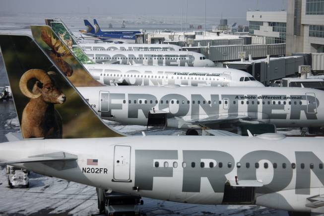 In this Feb. 22, 2010, file photo, Frontier Airlines jetliners sit stacked up at gates along the A concourse at Denver International Airport.