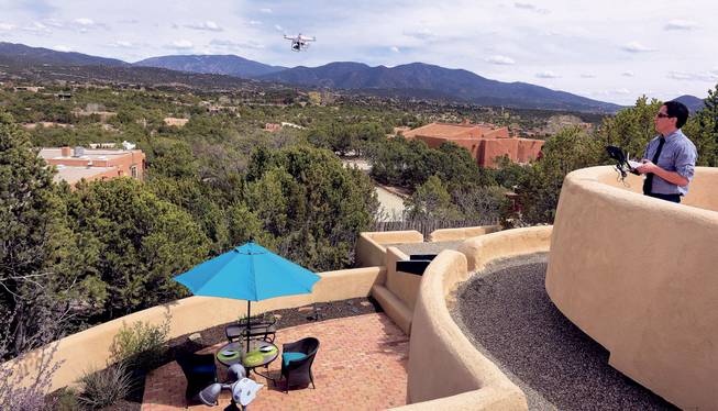 Brian Tercero, of Keller Williams Realty, uses a drone to create a high definition video of a property that he is trying to sell for a client, April 18, 2014. He feels video footage from a drone can better convey the appeal of a property than standard marketing photos.