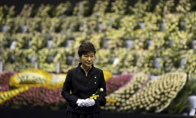 South Korean President Park Geun-hye pays tribute to the victims of the sunken ferry Sewol at a group memorial altar in Ansan, south of Seoul, South Korea, Tuesday, April 29, 2014. 