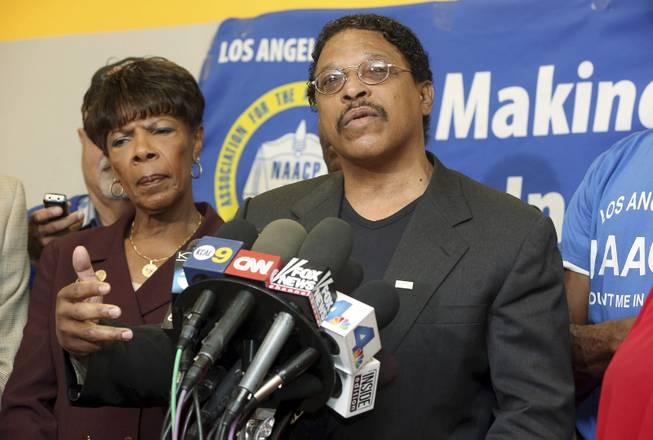 Leon Jenkins, right, president of the Los Angeles chapter of the NAACP, announces that Los Angeles Clippers owner Donald Sterling will not be receiving his lifetime achievement award, at a news conference in Culver City, Calif., Monday, April 28, 2014. The Clippers owner allegedly made racially charged comments in a recorded conversation. Sterling had been slated to receive the honor on May 15 as part of the 100th anniversary celebration of the group's Los Angeles chapter.