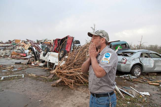 John Smith reacts after seeing what's left of his auto repair shop in Mayflower, Ark., Monday, April 28, 2014, after a tornado struck the town late Sunday. Mayflower was hit hard Sunday after a tornado system ripped through several states in the central U.S. and left more than a dozen dead in a violent start to this year's storm season, officials said.  