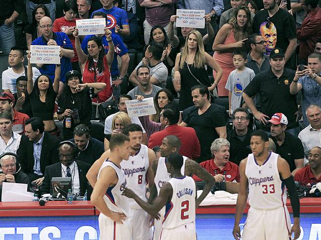 Fans hold up signs in support of the Los Angeles Clippers before Game 5 of an opening-round NBA basketball playoff series Tuesday, April 29, 2014, in Los Angeles. 