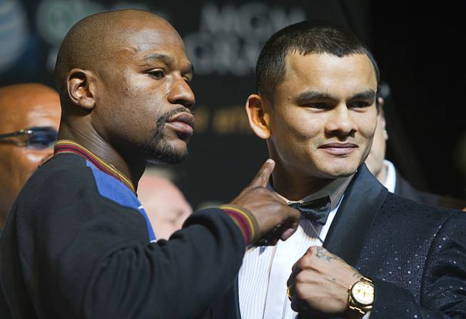 WBC welterweight champion Floyd Mayweather Jr. and WBA champion Marcos Maidana of Argentina attend a news conference at MGM Grand on Wednesday, April 30, 2014. The two champions will meet in a WBC/WBA unification fight at MGM Grand Garden Arena on Saturday.