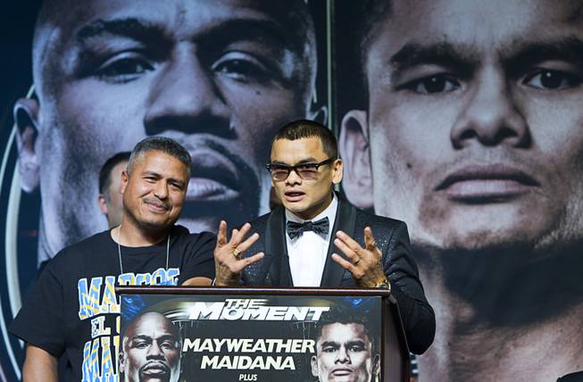 WBA welterweight champion Marcos Maidana of Argentina speaks during news conference at the MGM Grand Wednesday, April 30, 2014. Trainer Robert Garcia is at left. Maidana will challenge WBC welterweight champion Floyd Mayweather Jr. in a WBC/WBA unification fight at the MGM Grand Garden Arena on Saturday.