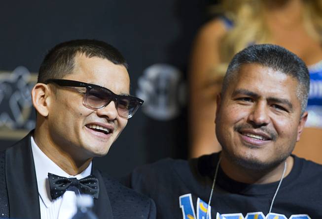 WBA welterweight champion Marcos Maidana, left, of Argentina attends a news conference with trainer Robert Garcia at the MGM Grand on Wednesday, April 30, 2014. Maidana will challenge WBC welterweight champion Floyd Mayweather Jr. in a WBC/WBA unification fight at the MGM Grand Garden Arena on Saturday.