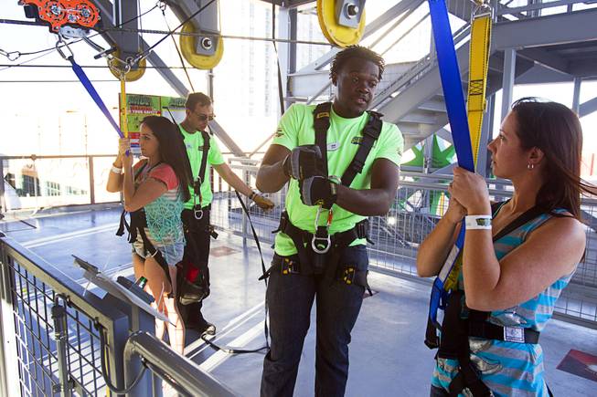 Launch operator Teon White gives instruction to Amanda (no last name provide) of Tennesee before she tries the new 850-feet-long SlotZilla Zipline at the Fremont Street Experience in downtown Las Vegas, Wednesday, April 30, 2014. A higher and longer 1700-feet-long Zoomline, which will propel flyers in a horizontal "superman" position at speeds up to 35 mph, is expected to open in June. The zip-line, part of the $12 million SlotZilla project, opened April 27, 2014.
