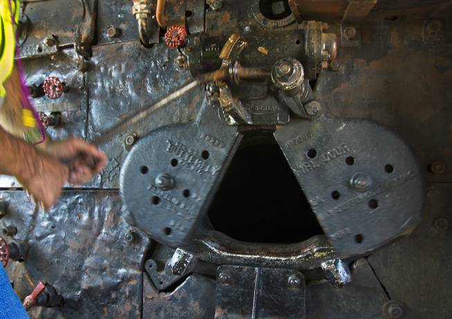 Ed Dickens, senior manager of heritage operations for the Union Pacific Railroad, works a butterfly fire door within the cab of the Big Boy No. 4014 steam locomotive stopped at the Union Pacific Railroad in Las Vegas on Wednesday, April 30, 2014.
