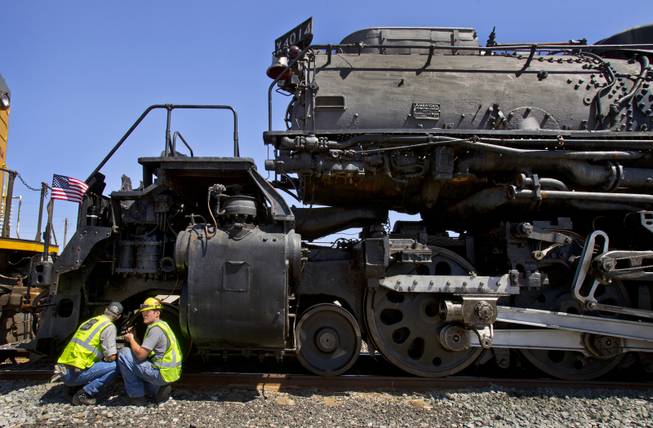 Ed Dickens, senior manager of heritage operations for the Union Pacific Railroad, confers with team member Austin Barker about the Big Boy No. 4014 steam locomotive stopped at the Union Pacific Railroad in Las Vegas on Wednesday, April 30, 2014.