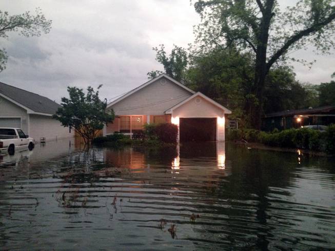 In this photo provided by Kyle Smith, floodwaters surround Smith's home in Pensacola, Fla., on Wednesday, April 30, 2014. Smith had to evacuate his home with his 18-month-old son Tuesday night after severe weather hit the Florida Panhandle, causing widespread flooding.