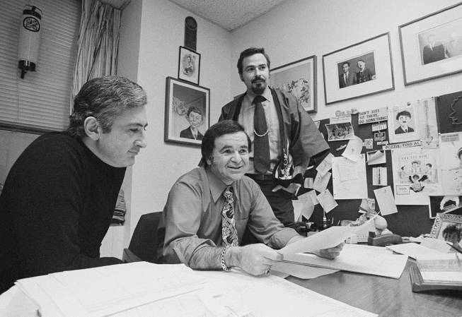 In this 1972 file photo, "Mad" magazine Editor Al Feldstein, center, sits with Art Director John Putnam, left, and a freelancer named Jack, at the magazine's New York headquarters. Feldstein, whose 28 years at the helm of Mad transformed the satirical magazine into a pop culture institution, died Tuesday, April 29, 2014. He was 88.