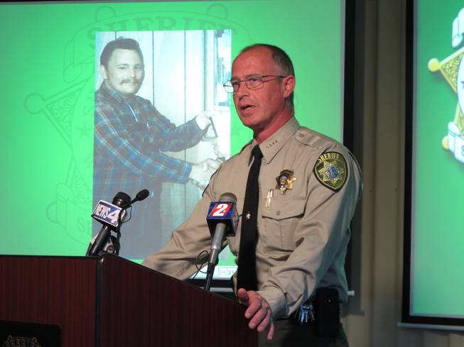 Storey County Sheriff Gerald Antinoro speaks to reporters at Washoe County sheriff's headquarters in Reno, Nev., Thursday, May 1, 2014, about the opening of an investigation into the apparent 1980 homicide of George Benson Webster of Sun Valley, who is pictured in the background.