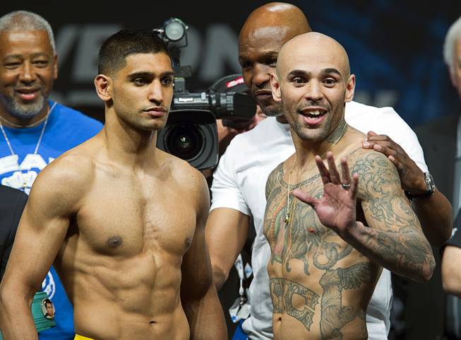 Amir Khan, left, of Britain and Luis Collazo  pose during an official weigh-in at the MGM Grand Garden Arena Friday, May 2, 2014. The boxers will meet for a welterweight fight at the arena on Saturday.